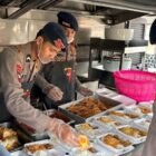 Personel Brimob Polda Jatim menyiapkan dan menyalurkan 300 paket makanan kepada masyarakat terdampak karhutla di Desa Jatiarjo, Senin (26/10/2026).